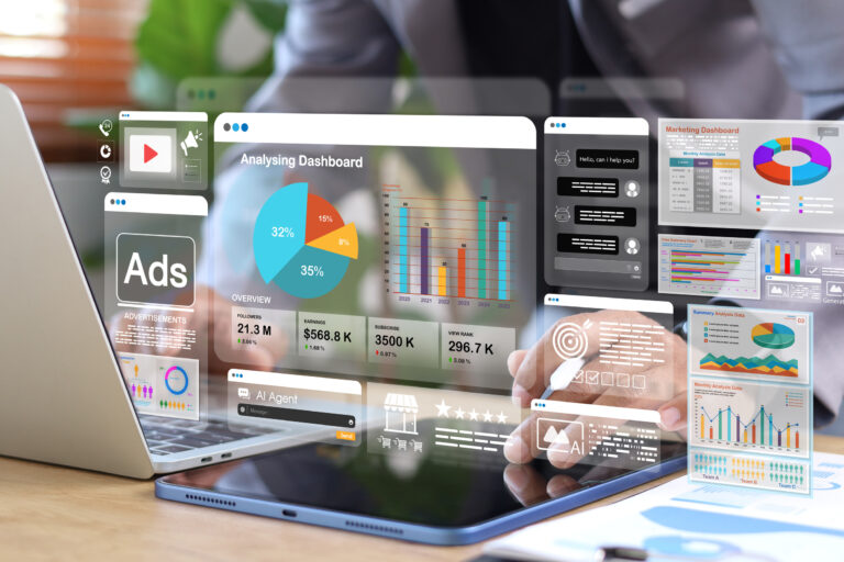 Business analytics and AI marketing dashboard displayed on digital tablet and laptop. Data visualization, advertising performance, automation, and business intelligence concept.
